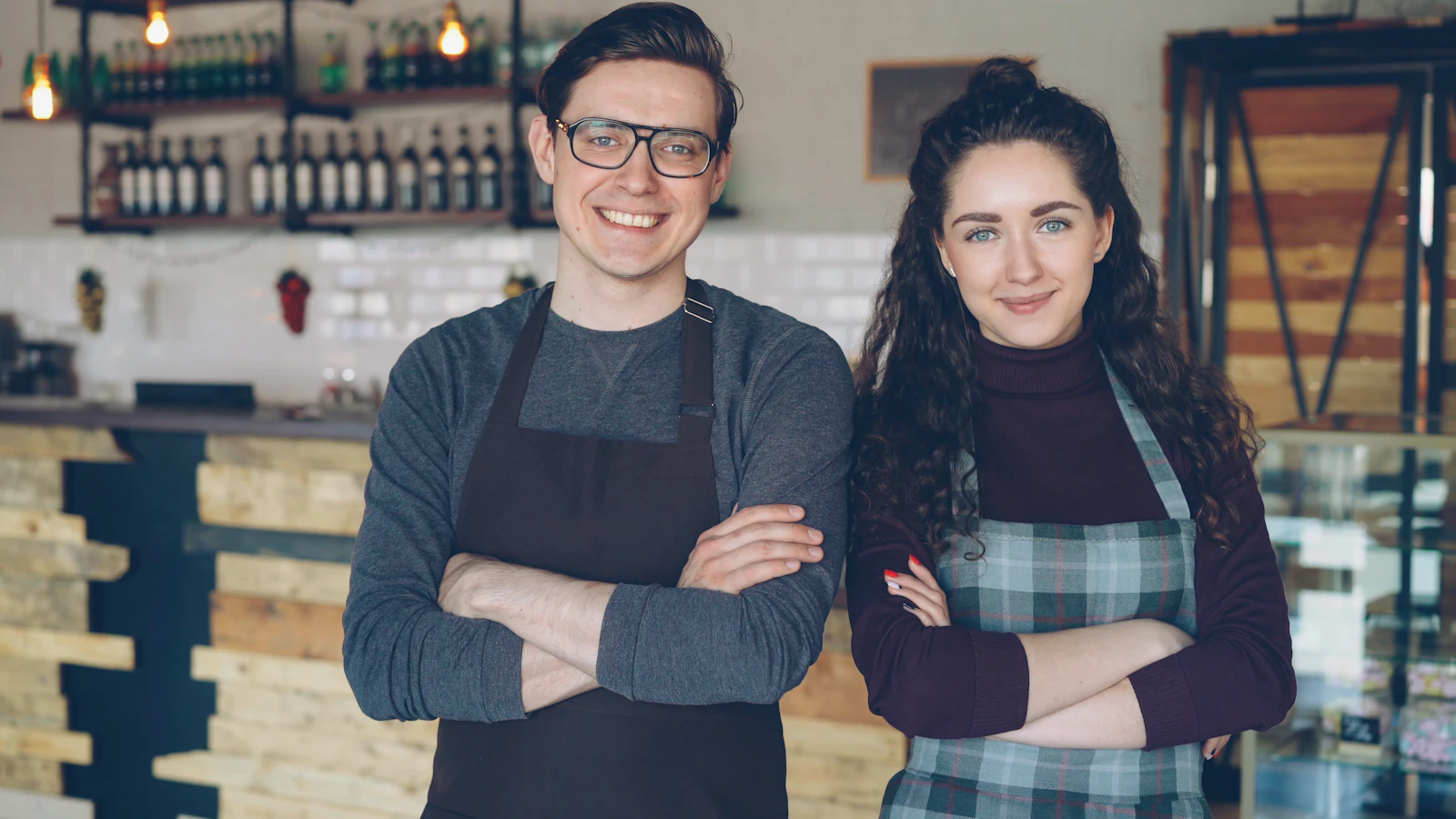 Two cafe owners proudly stand together